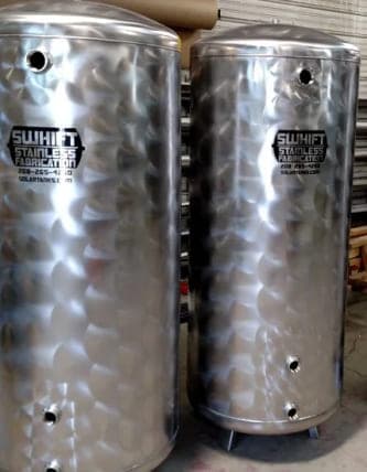 Two Swhift stainless steel tanks in a soft swirl finish, marked with the Swhift logo